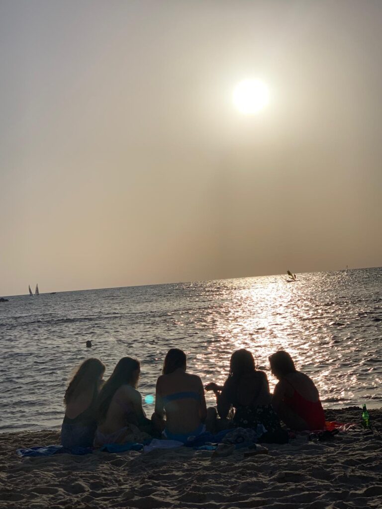 girls on beach at sunset